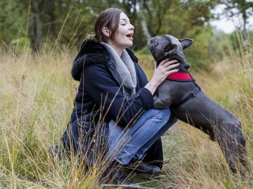 a woman playing with its dog!