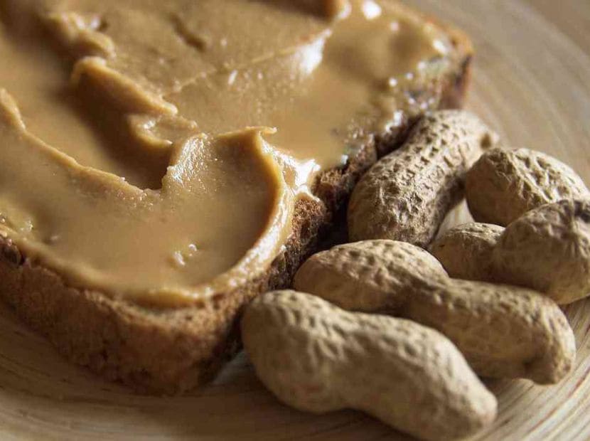 raw peanuts placed beside butter